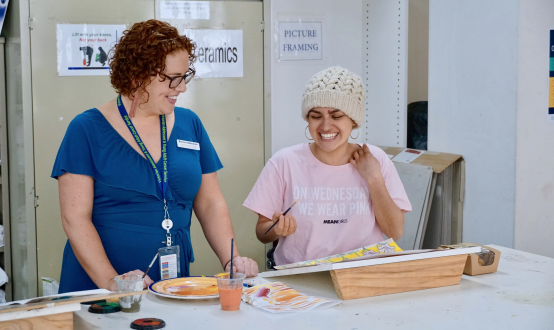 clinician and young woman painting