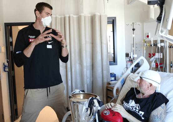 Mason Cox talking to a Peter Mac patient